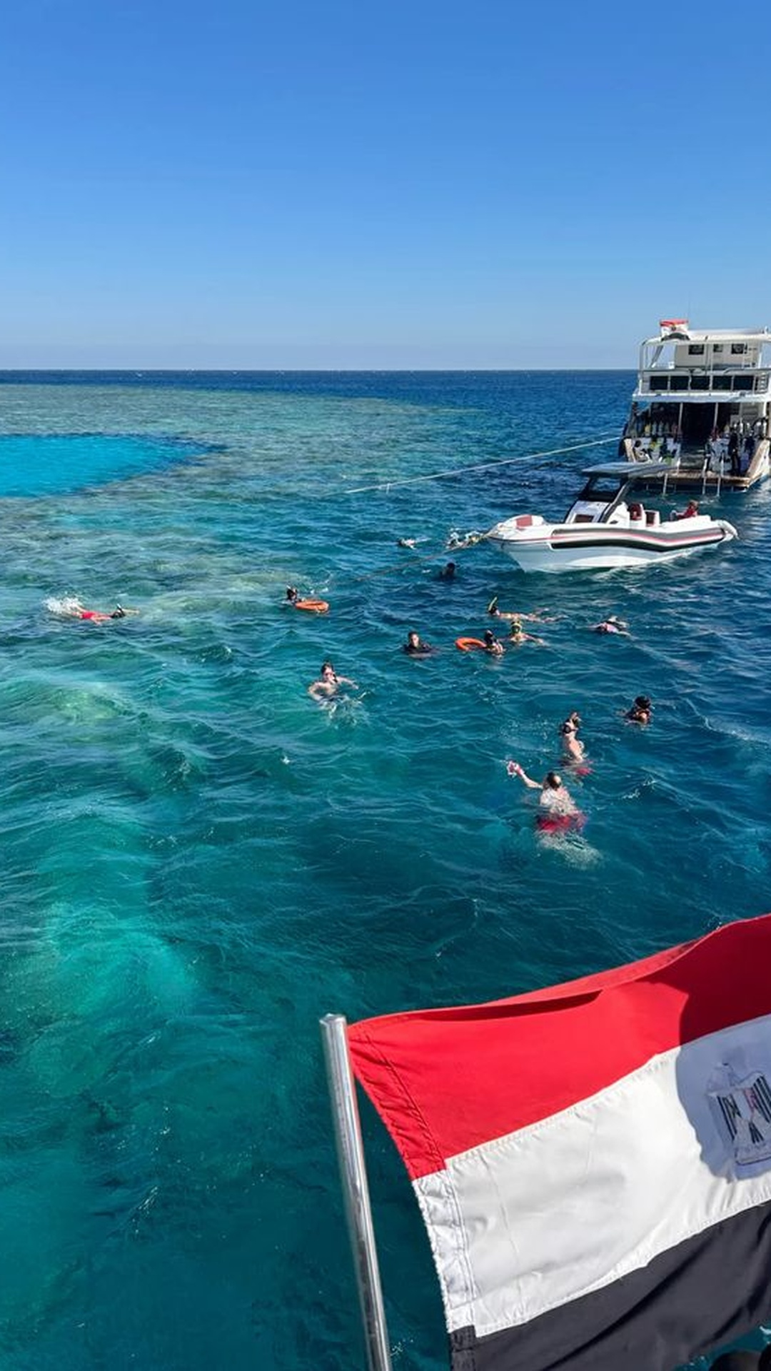 Speedboat and swimmers in the clear water of the Red Sea