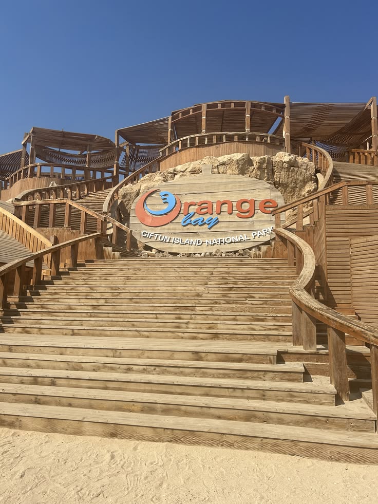 Orange Bay sign on the wooden stairs at the island