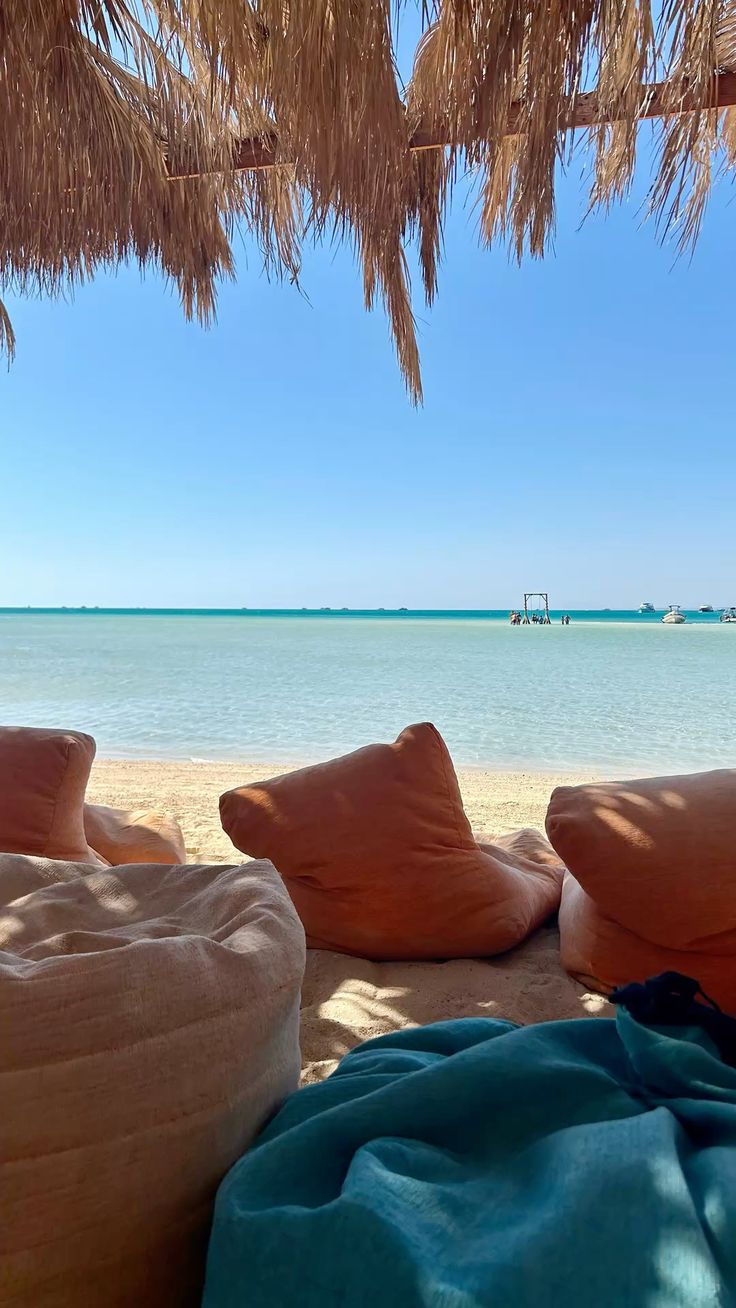 Bean bags on the sand facing the calm water